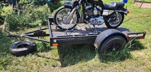 lot 3 image: 5ft x 8ft All Steel 2200lb Axle Trailer with Deck, Removable Wheel Chock and Tie Down Points. Includes (2) sets of Metal Ramps and Jack.