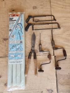 lot 703 image: Antique Hand Tool Collection - Hacksaws, Hand Drills, and Tin Snips with Frost King Pipe Insulation