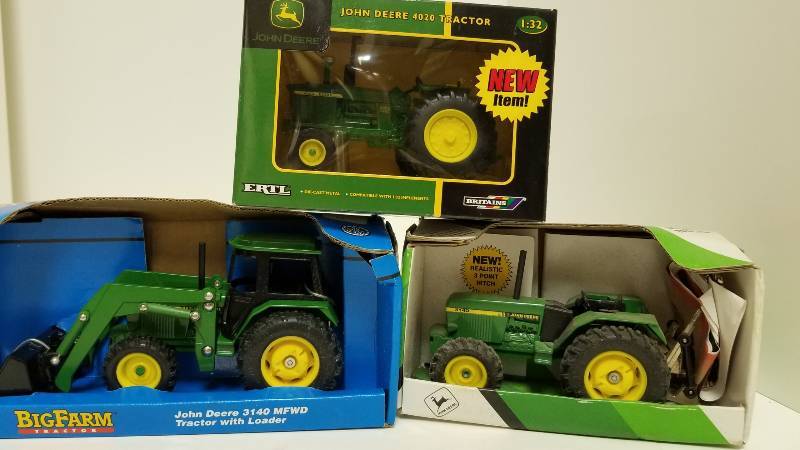 lot 1178 image: 3 Ertl John Deere Tractors, all 132 scale, JD 3140 MFWD WLoader (5743)JD Utility Tractor (5537)JD 4020 Tractor (15609), all NIB