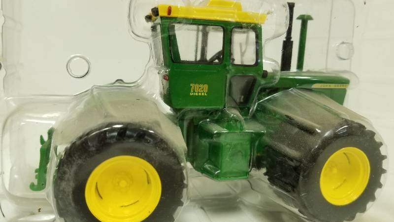 lot 1179 image: Ertl John Deere 7020 Diesel wduels front and back, perhaps 132 scale, no box but sealed in plastic  See Pix