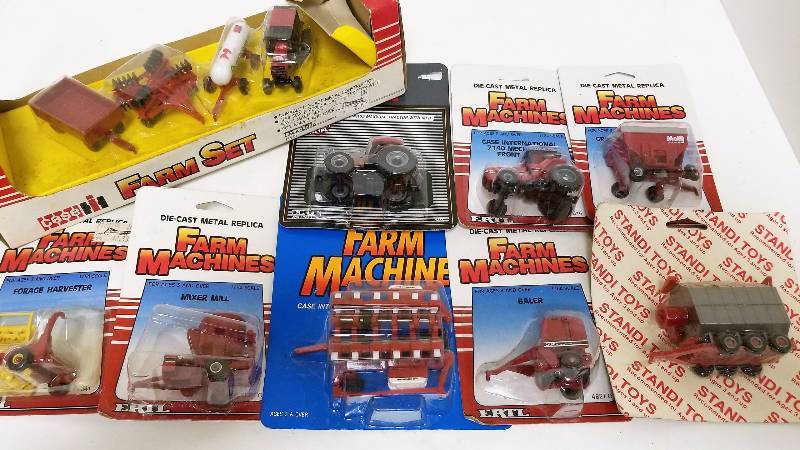 lot 1214 image: 9 Ertl 164 items, Case IH Farm Set, 1379, 2 Case IH Tractors, 4271, 616 Case IH 12 row planter, 656Case IH Mixer mill, 480FON Holland Forage Harvester, 341 M&W Gravity Feed Wagon, 9277Grain Drier Case IH Bailer, 482FO, NIB
