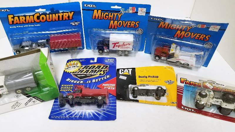 lot 1217 image: 7 Ertl 164 Items, Dually PU wGrain Trailerr, 4337Cat Dually PU, 2332Fertilizer Tk, 4254 JD Milk Tanker, 5545IH Straight Truck, 4295IH Wrecker, 4297IH Snow blade Tk,  NIB