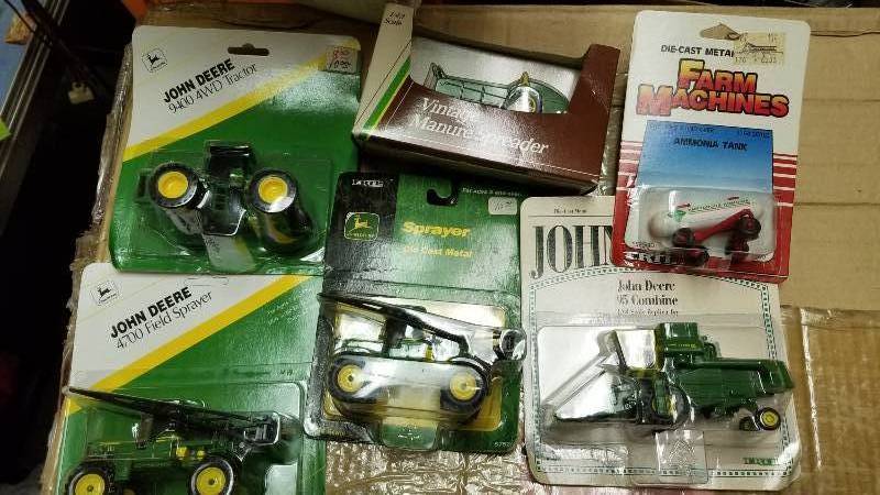 lot 1220 image: 6 Ertl 164 items, JD 95 Combine w4 row corn head, 5819,  2 ea. JD 4700 Field Sprayers, 5752, JD 9400 4WD Tractor wtriple tires, 5937, JD Ventage Manure Dspreader (143 scale), 5654, Ammonia Tank, 1500, All NIB