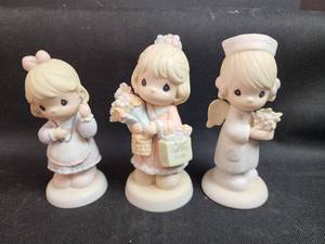 lot 179 image: Precious Moments Figurines Set of 3 - Shopping, Nurse, and Angel