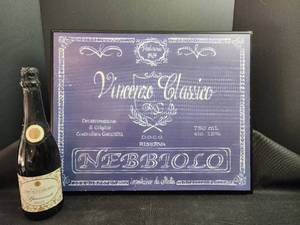 lot 269 image: Italian wine promotional display featuring a purple sign for Vincenzo Classico Nebbiolo D.O.C.G. Riserva from 1929, 750mL,