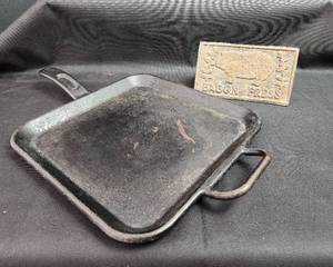 lot 142 image: Lodge Cast Iron Griddle marked 12BG US Made and Bacon Press