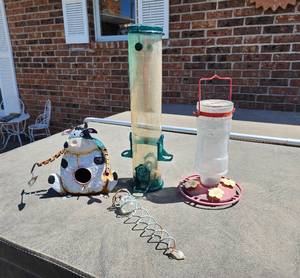 lot 927 image: Bird Feeder Collection - Decorative Cow House, Tube Feeder, and Hummingbird Feeder