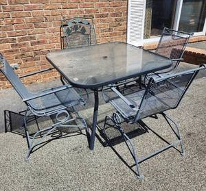 lot 935 image: Wrought Iron Patio Set with Glass Top Table and 4 Spring Chairs - Has 5th Chair That Needs Welded
