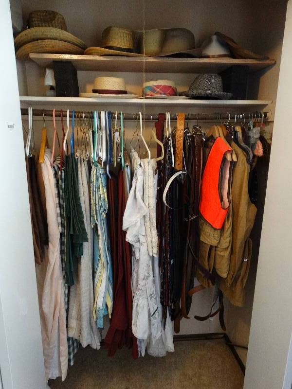 lot 162 image: All contents of entry closet- clothing, linens, hats