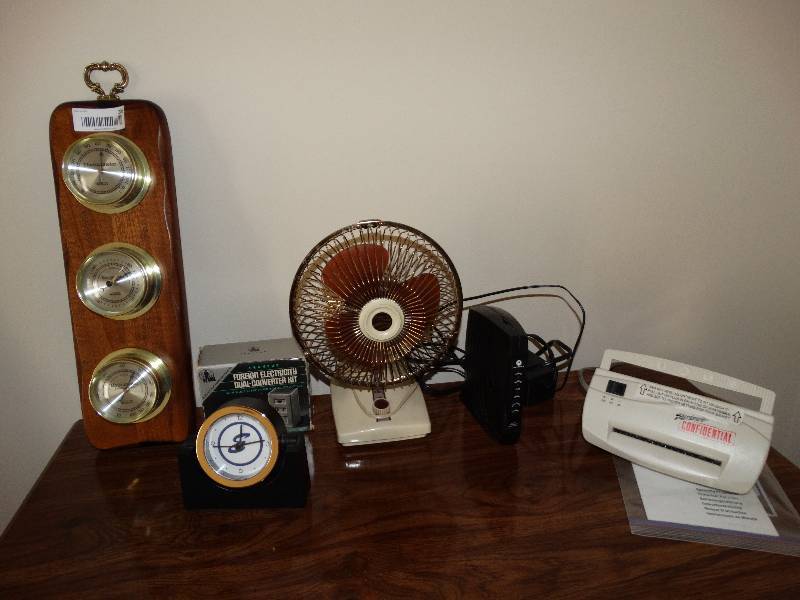 lot 203 image: All contents on top of dresser, Barometer, clock, fan, converters, shredder, modem