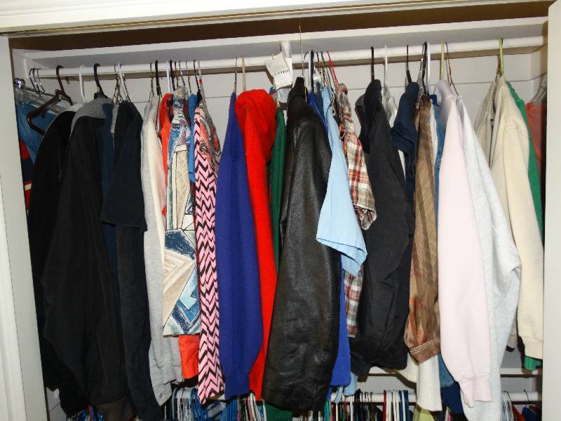 lot 208 image: Coats and sweat shirts on top racks of closet