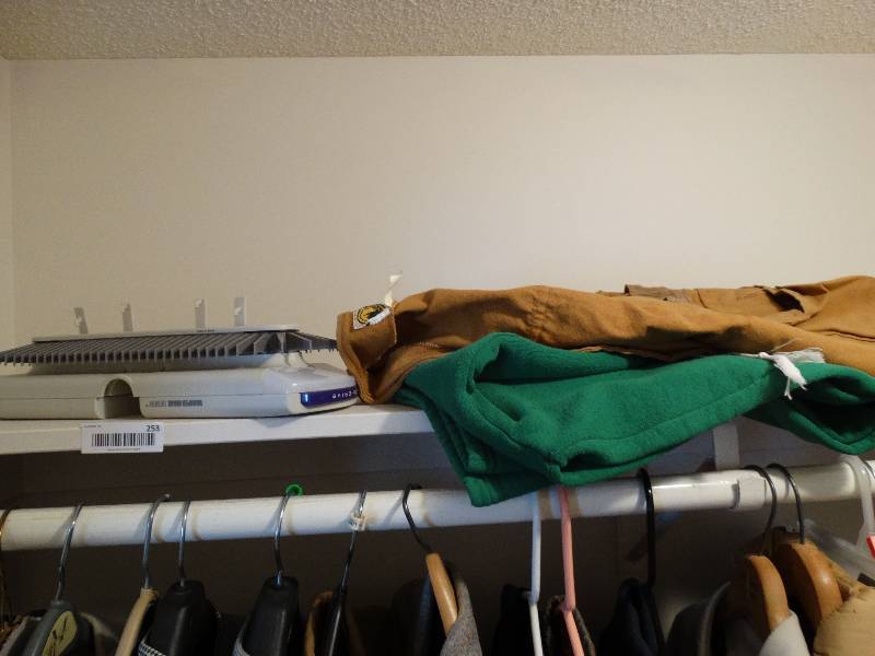 lot 253 image: Lot of mens clothing in closet and tie rack