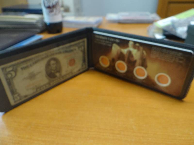 lot 156 image: Abraham Lincoln 1953 red seal $5 bill & 2009 uncirculated bicentennial coins in book