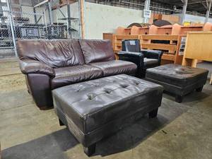 lot 21747 image: Brown Vinyl Love Seat, Foot Rest, Black vinyl Chair And Foot Rest