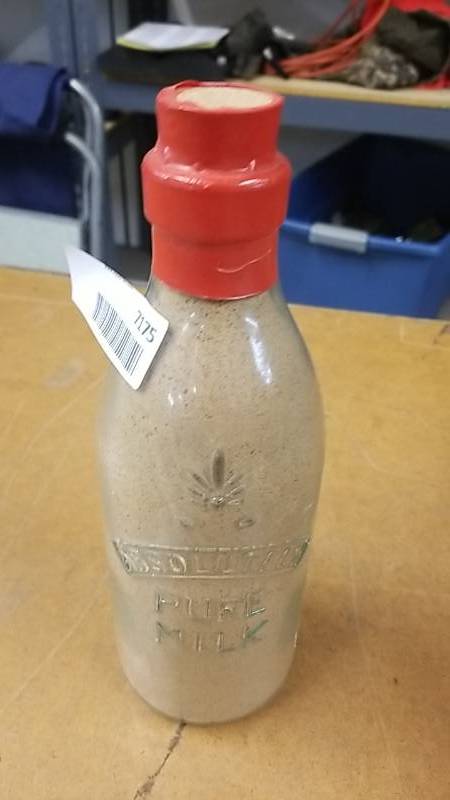 lot 7175 image: Cool Glass Bottle Filled With Dry Milk