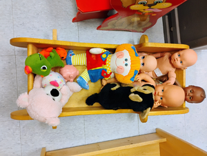 lot 924 image: Wooden Toy Cradle with Assorted Plush Toys and Baby Dolls. 10x30x18