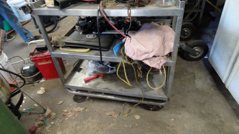 lot 1859 image: Stainless steel shop cart with contents, chains, animal trap.