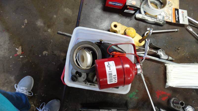 lot 1911 image: Tape measure, duck tape, hand drill and oil can.