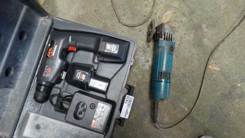 lot 1930 image: Skill drill with battery and charger and a Makita disc grinder.