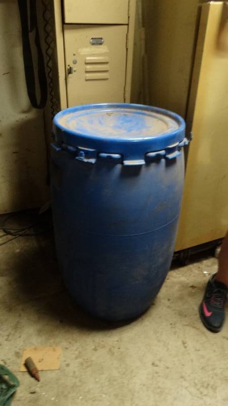 lot 1986 image: Blue plastic barrel with shop rags.