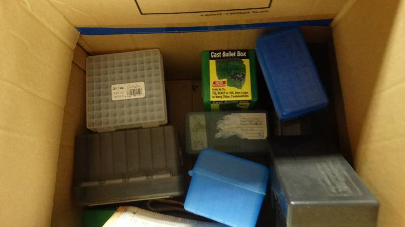 lot 1992 image: 15 empty bullet boxes and 1 gun holster.