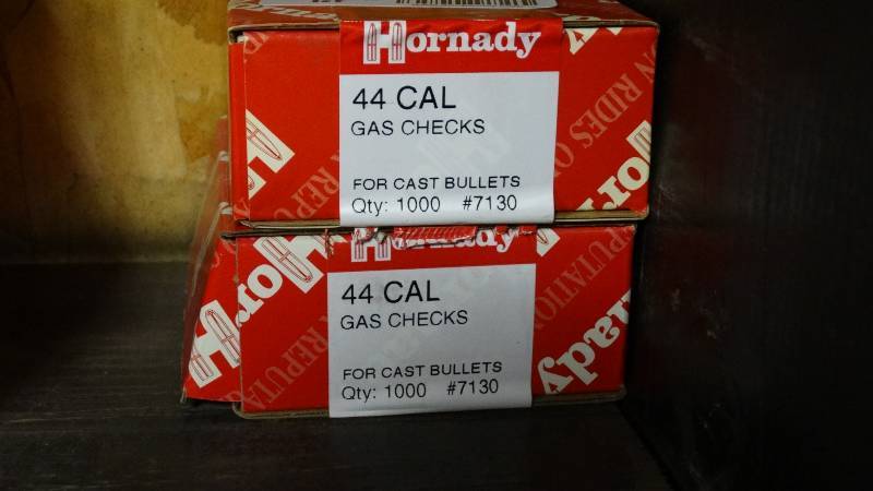 lot 5078 image: 3- boxes of 44 cal hallow point bullet tips and 2 boxes of .44 cal gas checks.