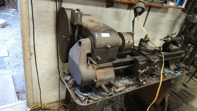lot 5135 image: Logan metal lathe with various tooling and stand.