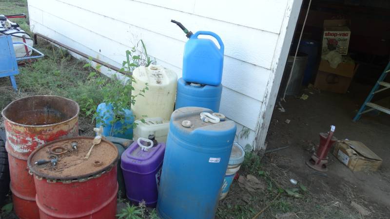 lot 5175 image: Lot of gas cans and 2 metal barrels.