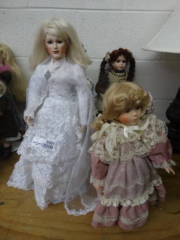 lot 3561 image: 4 Porcelain Stand up Dressy Dolls.