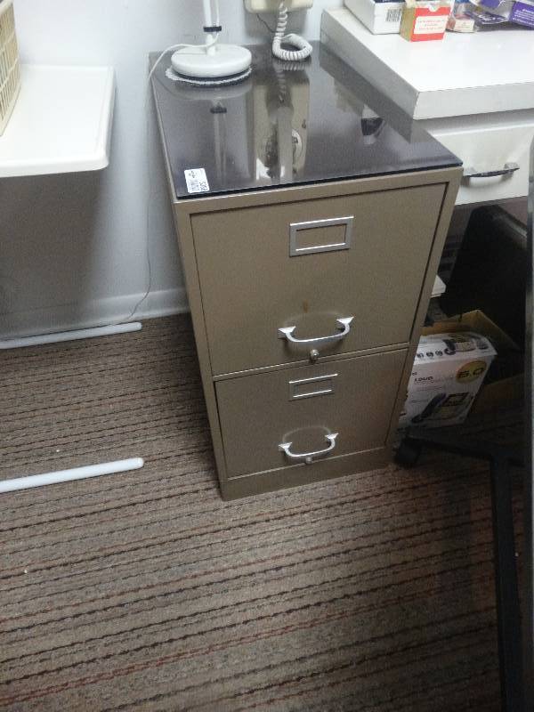 lot 5388 image: File cabinet with glass top and contents.