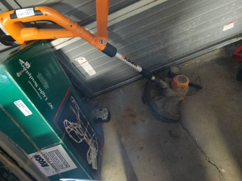 lot 5493 image: Worx battery operated weed eater.