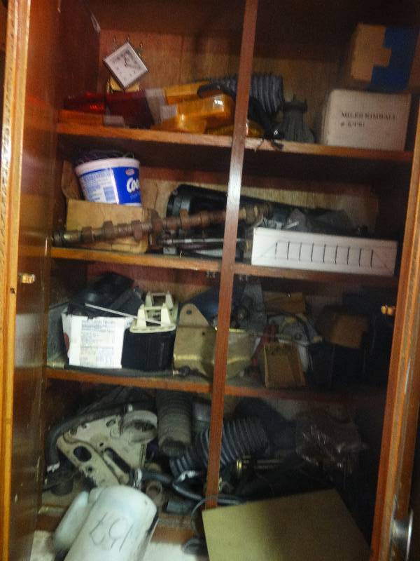 lot 5530 image: 2 Cabinets full of volvo car parts with a vice and a step ladder.