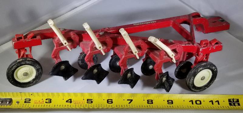 lot 296 image: International Red- Plow- Tractor Toy Implement