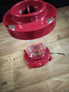 lot 2282 image: Red Plastic Hummingbird Feeder with Clear Reservoir