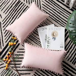 lot 2352 image: DEZENE 12x20 Throw Pillow Covers Pink 2 Pack Cozy Soft Pom-poms Velvet Rectangular Decorative Pillow Cases for Farmhouse Home Decor