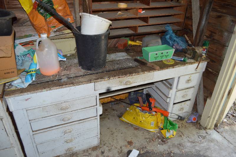 lot 4197 image: Contents of the NW Side of the Shed- Includes Snow Fence, Cabinet, Bench, and Misc.