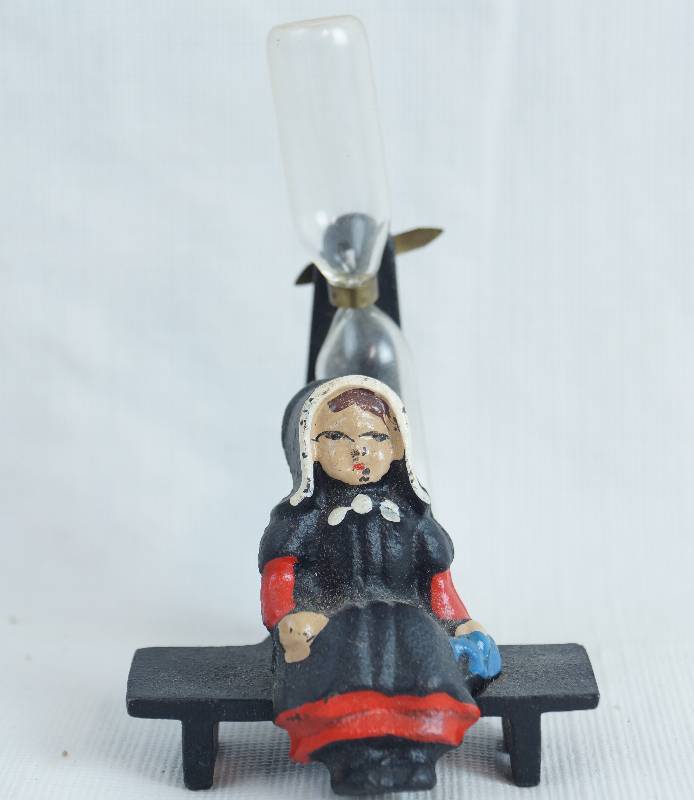 lot 2424 image: Cast Iron Painted Kitchen Timer w Pioneer Woman Sitting on a Bench - Timer Works Very Unique