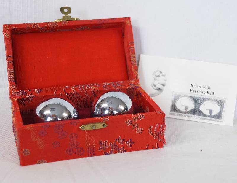 lot 3304 image: Metal Exercise  Relaxation Balls in a fabric box - Balls make a soothing jingle when shaken - in nice fabric covered box