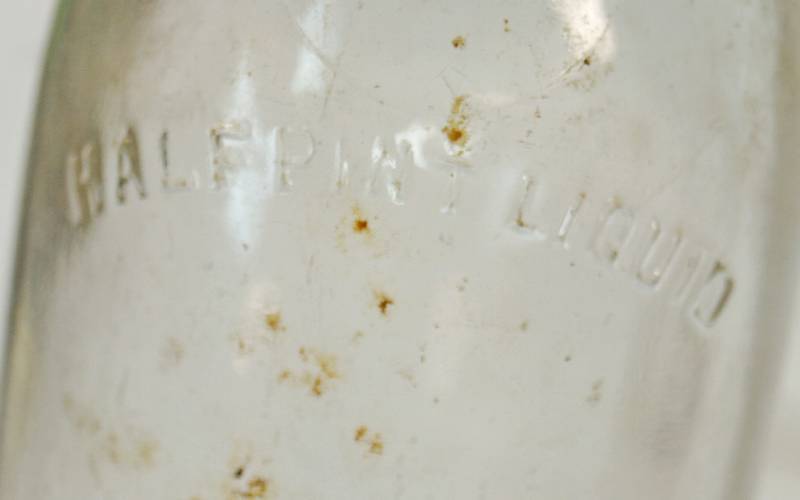 lot 1107 image: Lot of 2 Milk Bottles - Embossed Glass Neat