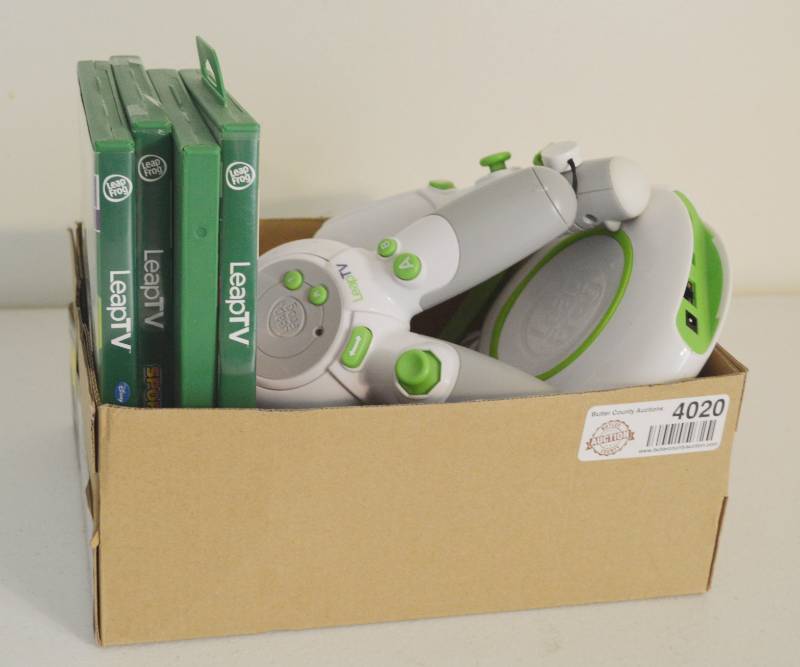 lot 4020 image: LeapFrog Leap TV Video game system. Two Controllers, 4 games and camera.
