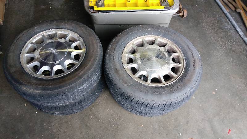 lot 4182 image: (1)set of 4 tires and wheels Ford Taurus, (2) 20565R15, (2) 20570R15