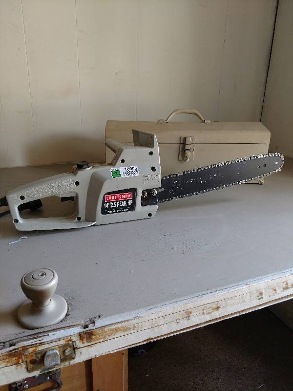 lot 10005 image: Electric Chainsaw and metal toolbox