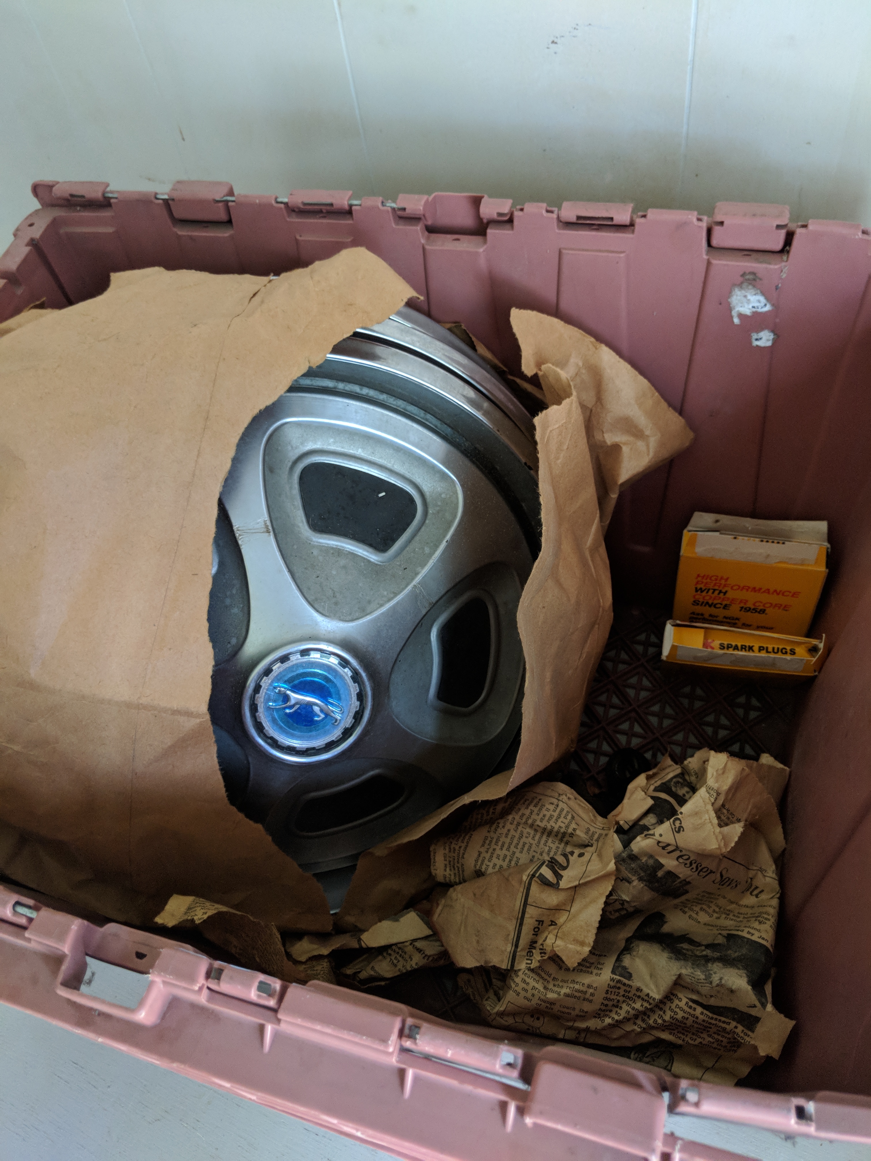 lot 10056 image: Jaguar hubcaps and spark plugs