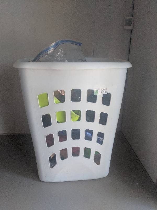 lot 10064 image: Laundry basket of water bottles and craft rubber stamps