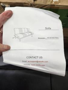 lot 35578 image: VECELO Faux Leather Couch Sofa Bed, 65 Folding Futon Sofa with Dual USB Charging Ports for Living Room, Black. ( MISSING A LEG)