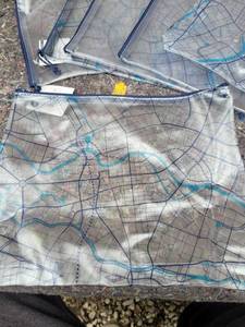 lot 222 image: LOT OF 7 - Clear Map Print Travel Pouch with Blue Zipper