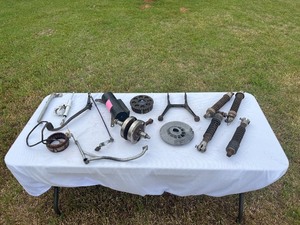 lot M121 image: Assorted Matchless Parts  Shocks, Kickstands, Clutch Sprocket, Crankshaft, Brake Levers, Muffler and More