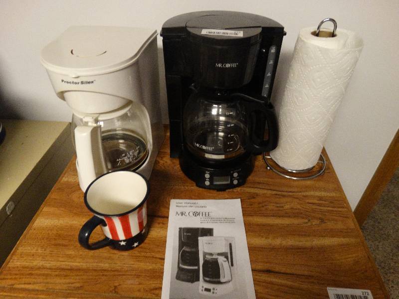 lot 273 image: 2 coffee pots and paper towel holder. 1 Proctor Silex and one Mr. Coffee
