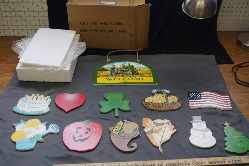 lot 103 image: John Deere Welcome Plaque- 12 Different Hangers- Seasonal