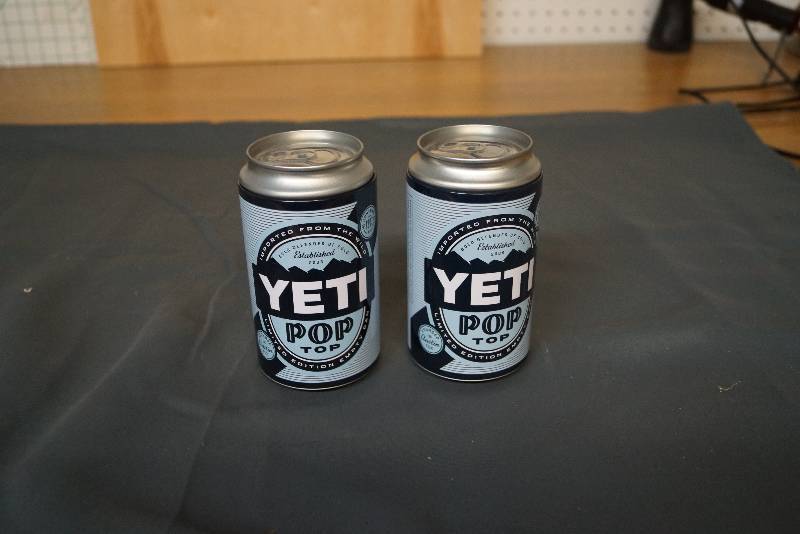lot 1161 image: Pair of Yeti Cans- Hide Your Stuff-  Lids Pop Off  and 1 Sticker